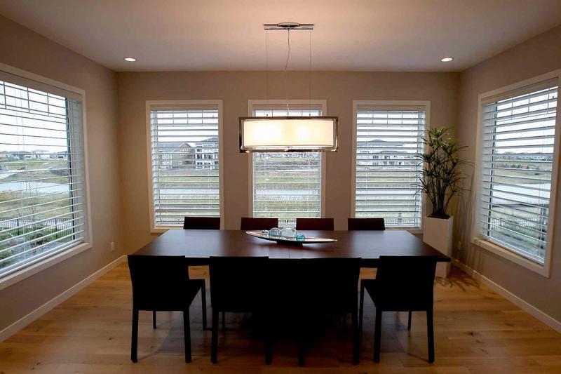 The semi-formal dining area next to the kitchen is essentially a sunroom with five windows (plus balcony door) surrounding with space to easily hold a table for 10.